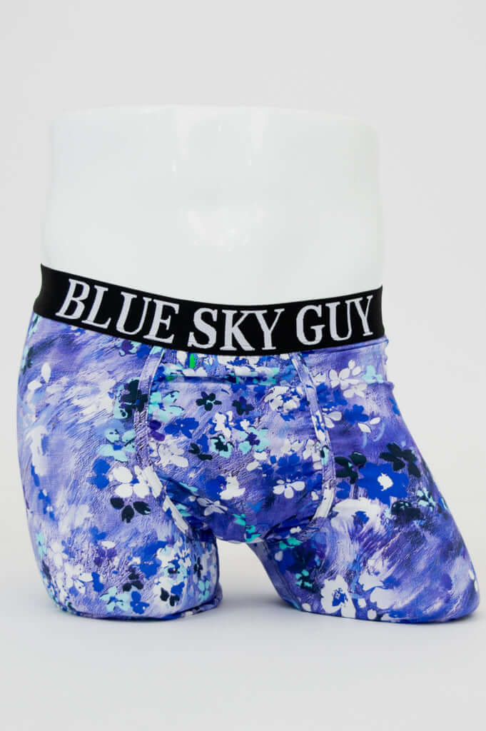 Front view of blue and white floral bamboo boxer briefs with black waistband that reads BLUE SKY GUY