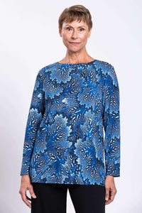 Front view of woman wearing a blue botanical print long top with boat neck