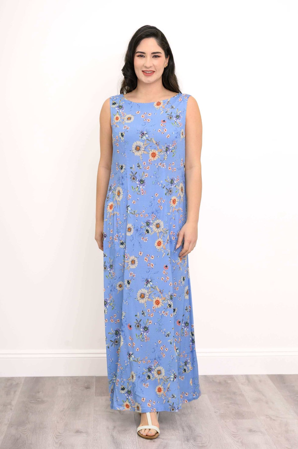 Front view of woman in a blue floral sleeveless shift maxi dress