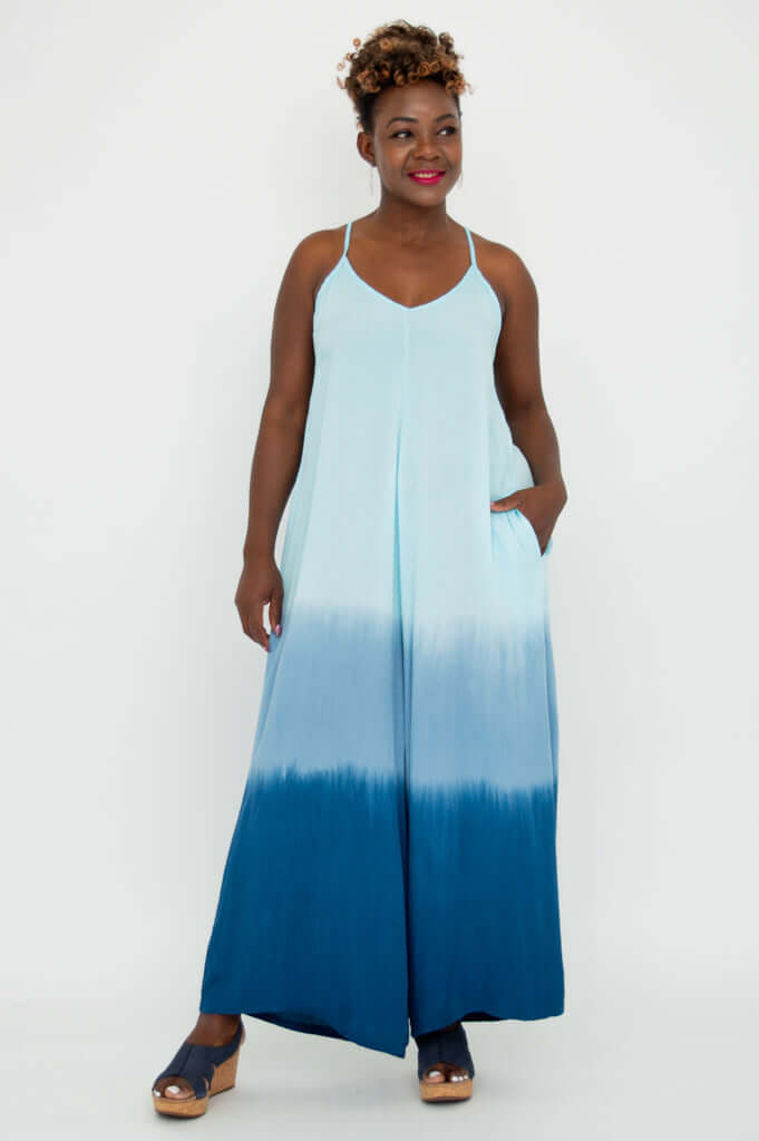 Front view of model wearing a blue ombre wide-leg jumpsuit with adjustable straps