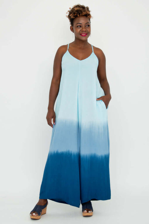 Front view of model wearing a blue ombre wide-leg jumpsuit with adjustable straps