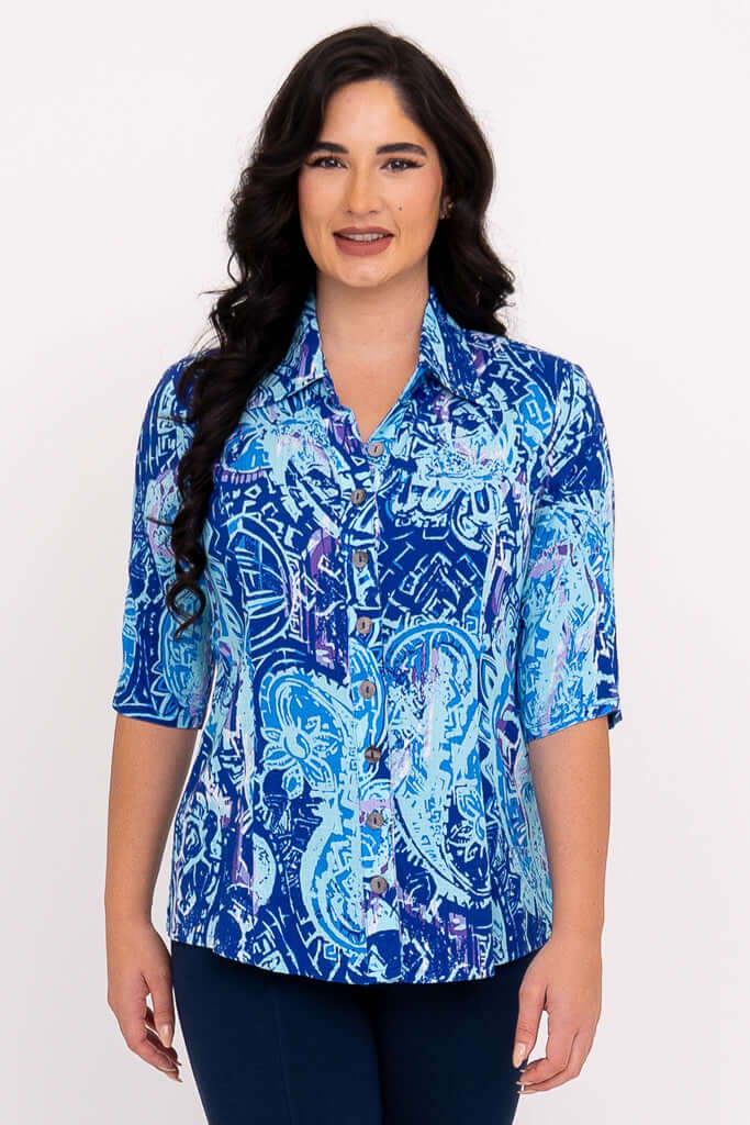 Front view of a woman wearing a blue patterned blouse with elbow-length sleeves