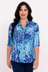 Front view of a woman wearing a blue patterned blouse with elbow-length sleeves
