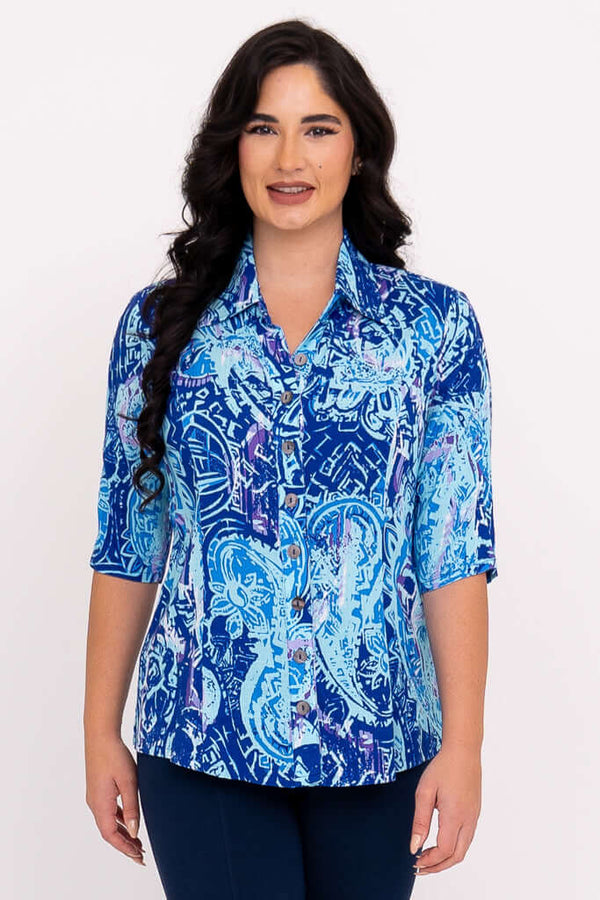 Front view of a woman wearing a blue patterned blouse with elbow-length sleeves