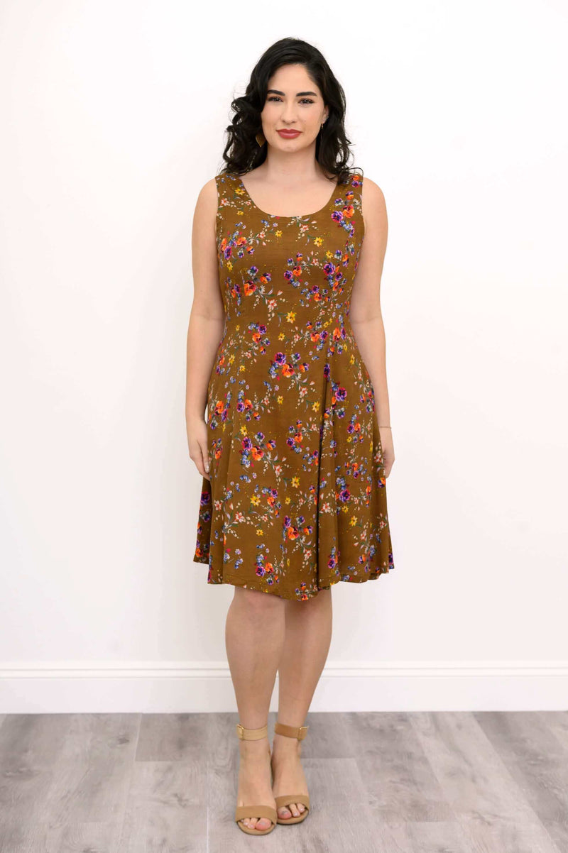 Front view of woman wearing a brown floral A-line dress with scoop neckline