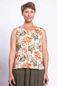 Front view of a woman wearing a sleeveless floral cropped tank with wide shoulder straps