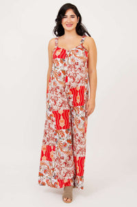 Front view of woman wearing a colorful floral patchwork jumpsuit with wide legs