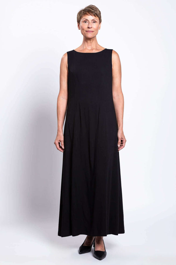 Front view of a woman wearing a full-length black sleeveless shift dress