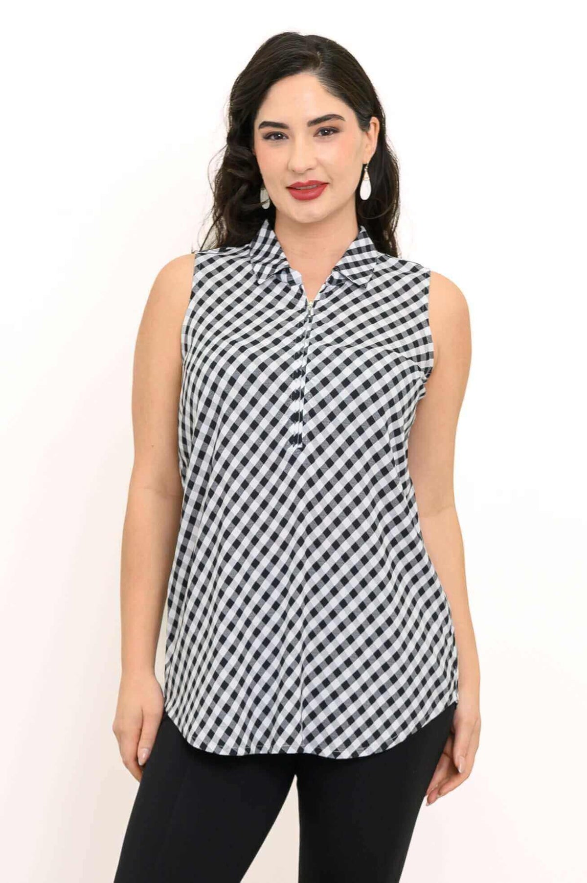 Front view of a woman wearing a sleeveless black and white gingham tank top