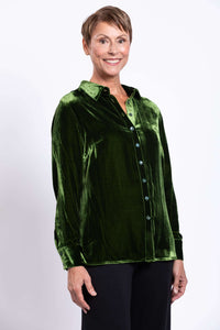 Front view of model wearing a green silk velvet blouse with shirt collar and button cuffs