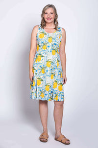 Model wearing sleeveless Arden dress with blue and yellow lemon tile print, front view