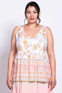 Front view of model wearing white and peach floral tiered tank top