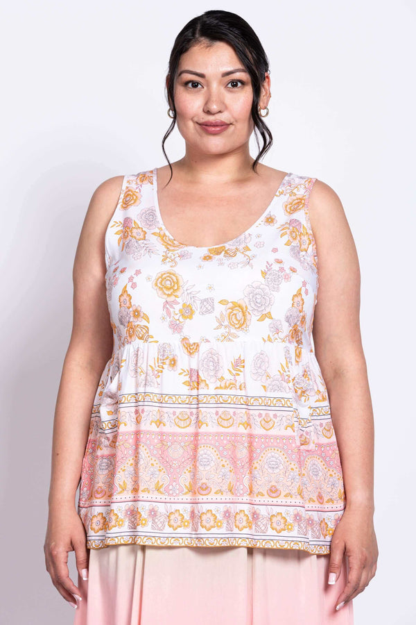 Front view of model wearing white and peach floral tiered tank top