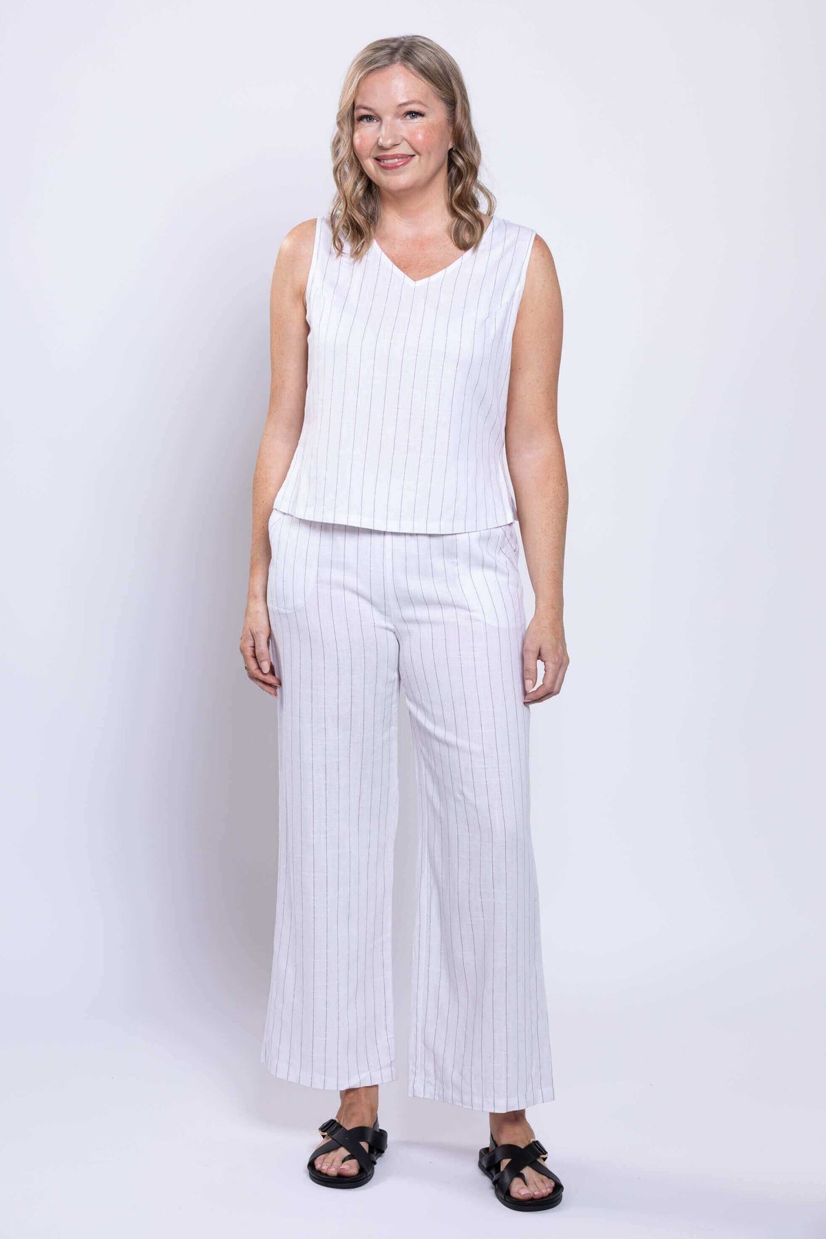 Front view of model wearing white striped wide-leg Parker Pant with sleeveless top