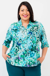 Front view of model wearing a blue and green floral bamboo-linen blouse