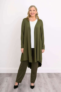 Model smiling in olive green long duster and pants, shown from the front