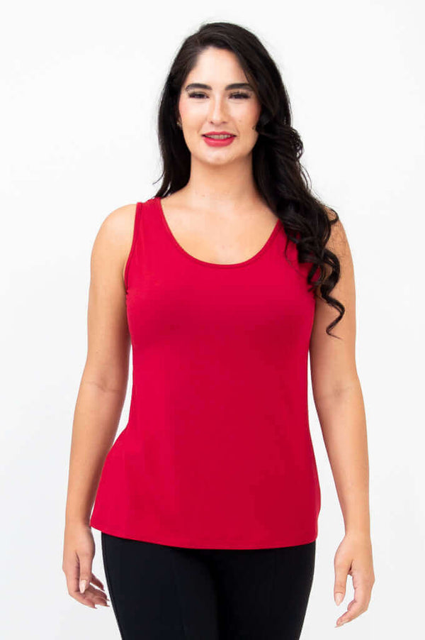 Front view of woman wearing a ruby red bamboo tank top with black pants