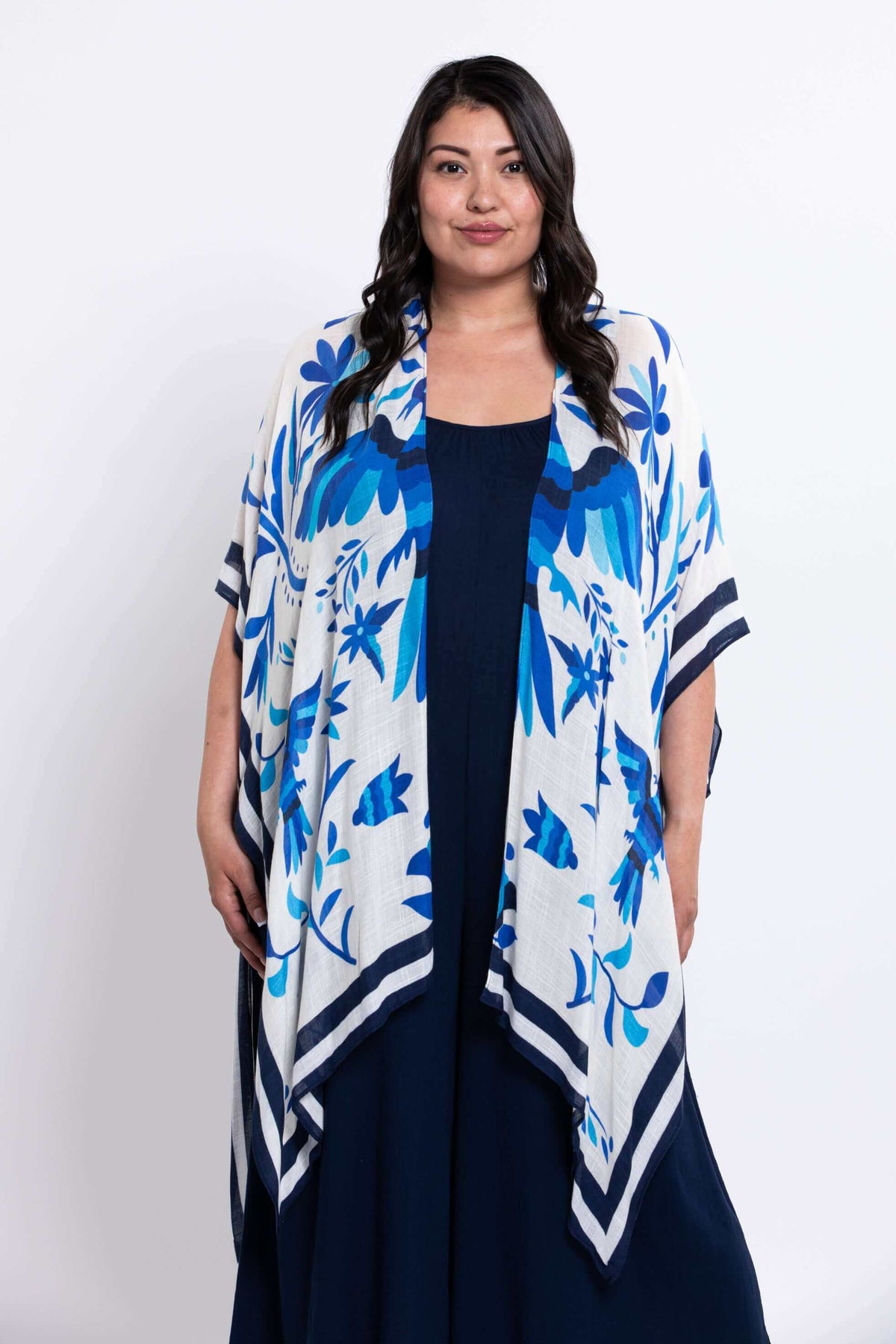 Front view of model wearing white and blue kimono wrap with floral pattern