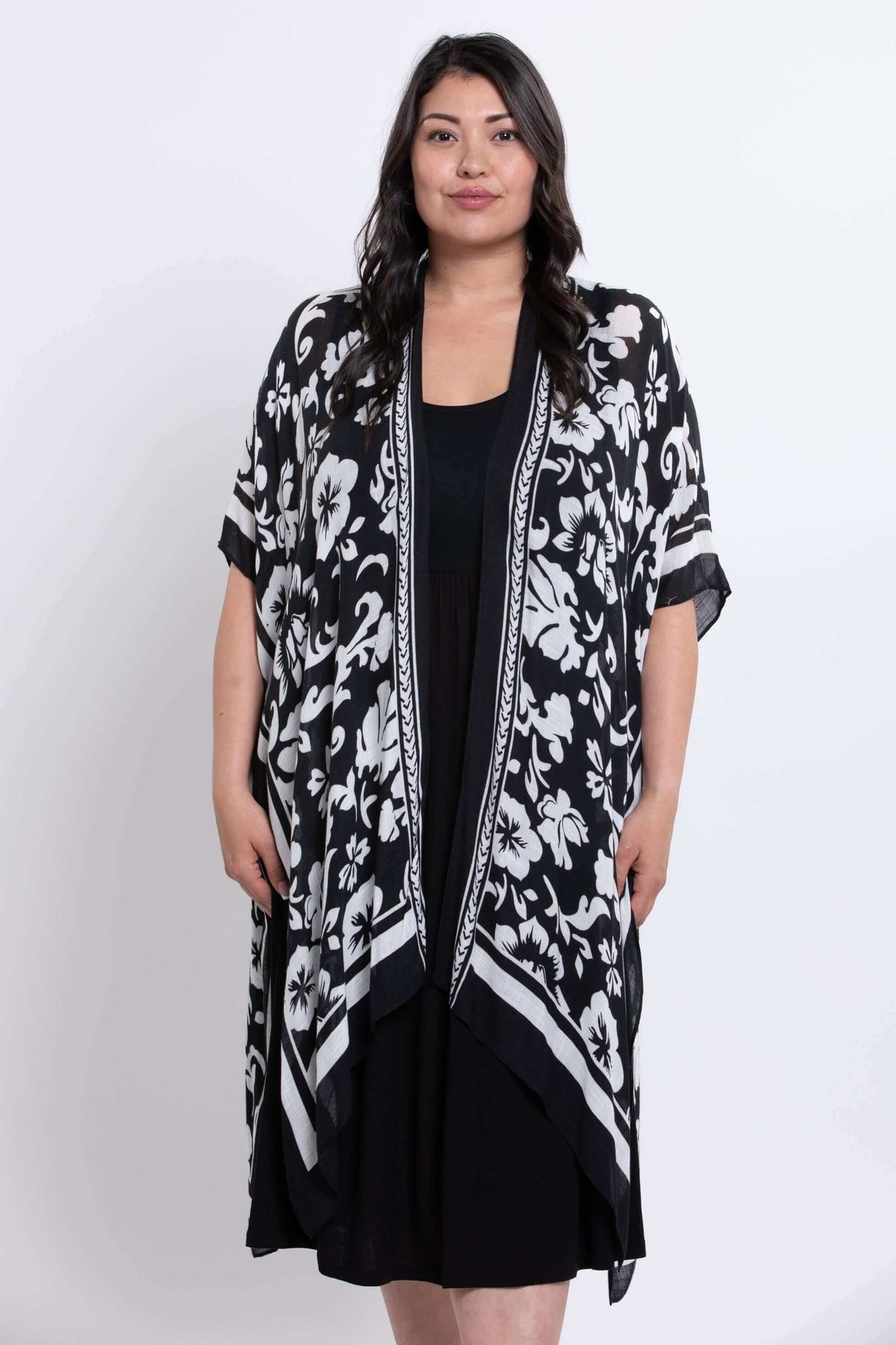Front view of model wearing a black floral kimono wrap