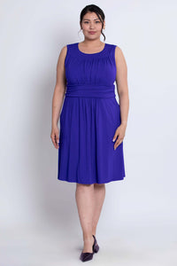 Front view of model wearing sleeveless purple bamboo dress with ruched bodice