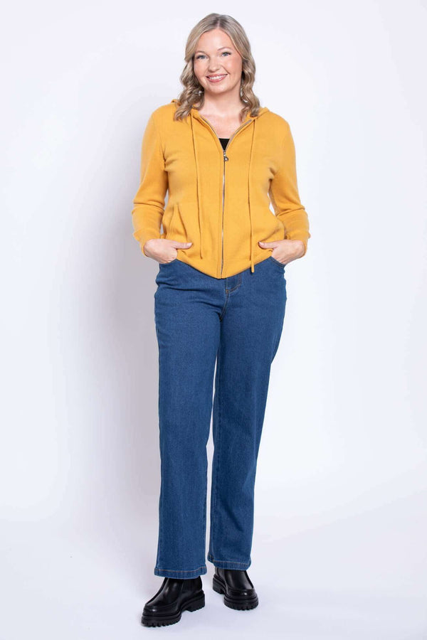 Front view of model wearing wide leg modern fit blue jeans with yellow zip hoodie