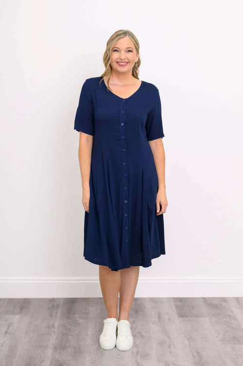 Front view of woman wearing a navy knee-length button-front dress with short sleeves