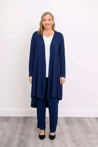Woman standing front-facing in a navy blue long duster cardigan and navy pants