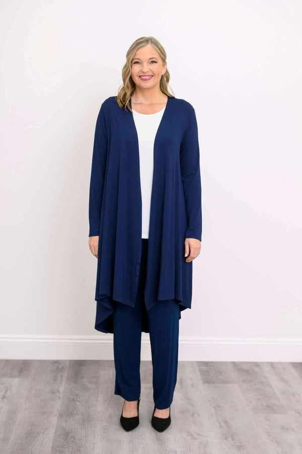Woman standing front-facing in a navy blue long duster cardigan and navy pants