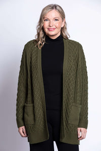 Front view of woman wearing olive green cable knit cardigan with patch pockets