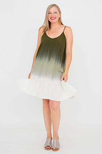 Woman wearing olive ombre mini dress with adjustable straps and flounce hem, front view, smiling