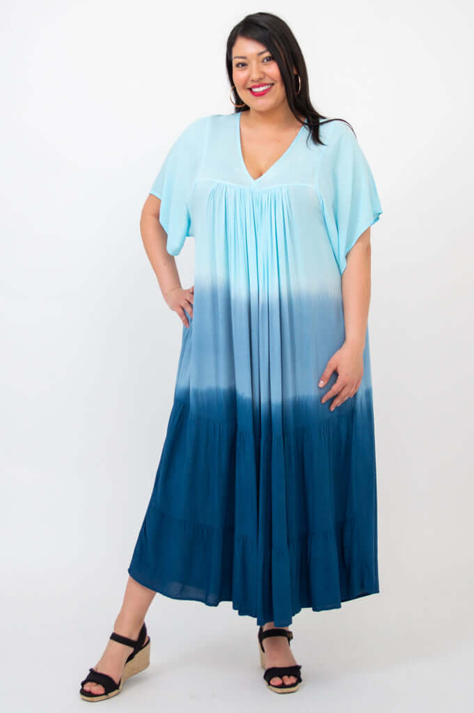Front view of woman wearing ombre blue tiered maxi dress with V-neck and short sleeves