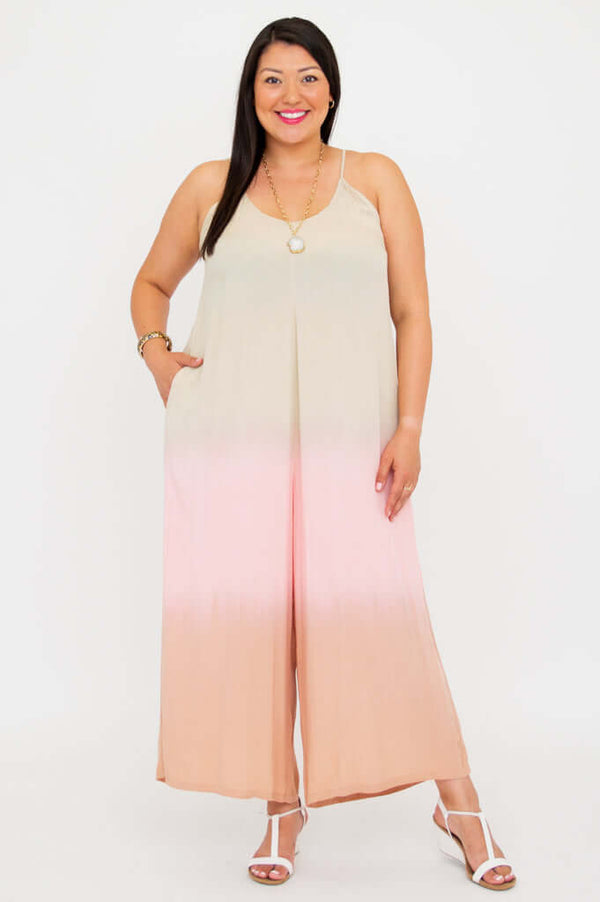 Front view of model wearing a beige to blush ombre wide leg jumpsuit with spaghetti straps