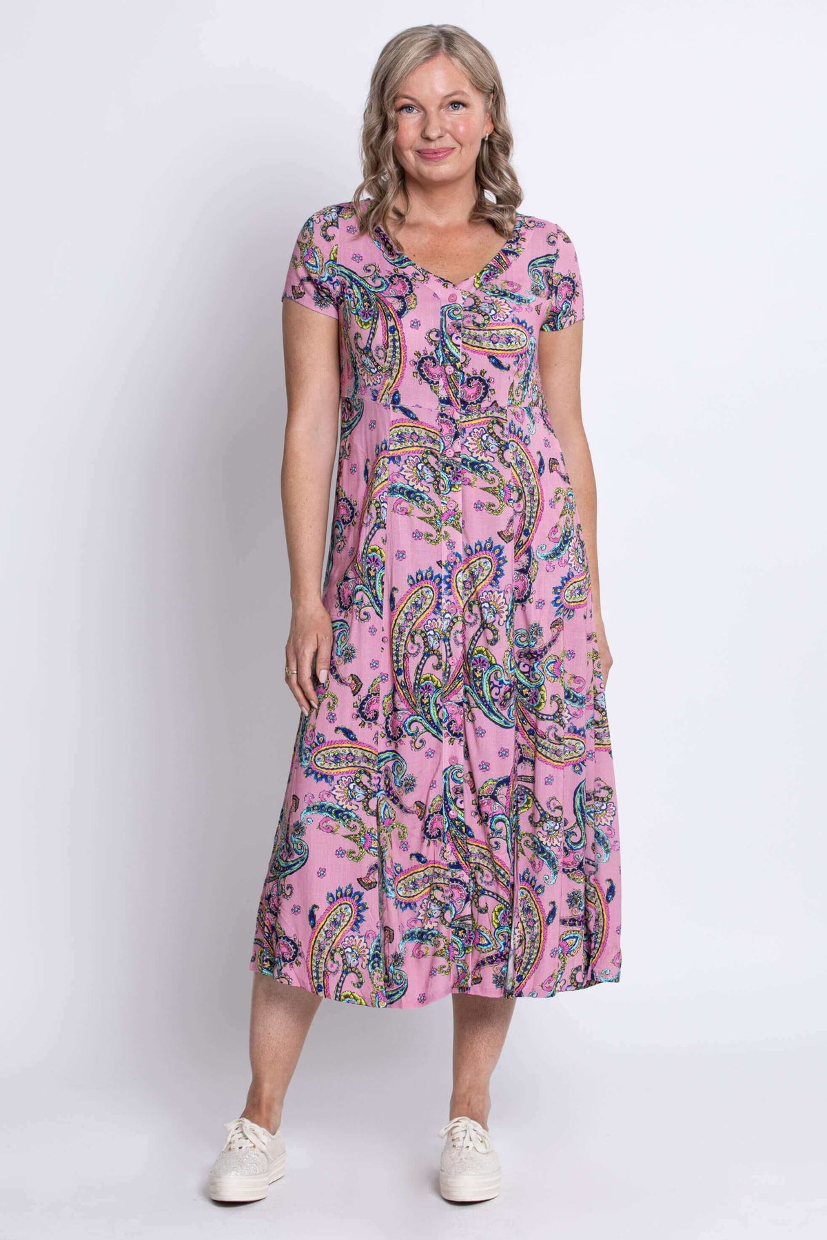 Front view of a woman wearing a pink paisley print midi dress with short sleeves
