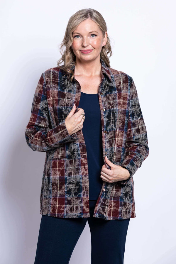 Front view of a woman wearing a plaid cotton jacket over a navy top