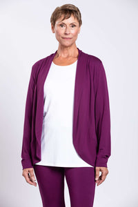 Front view of a woman wearing a plum bamboo French terry jacket over a white top