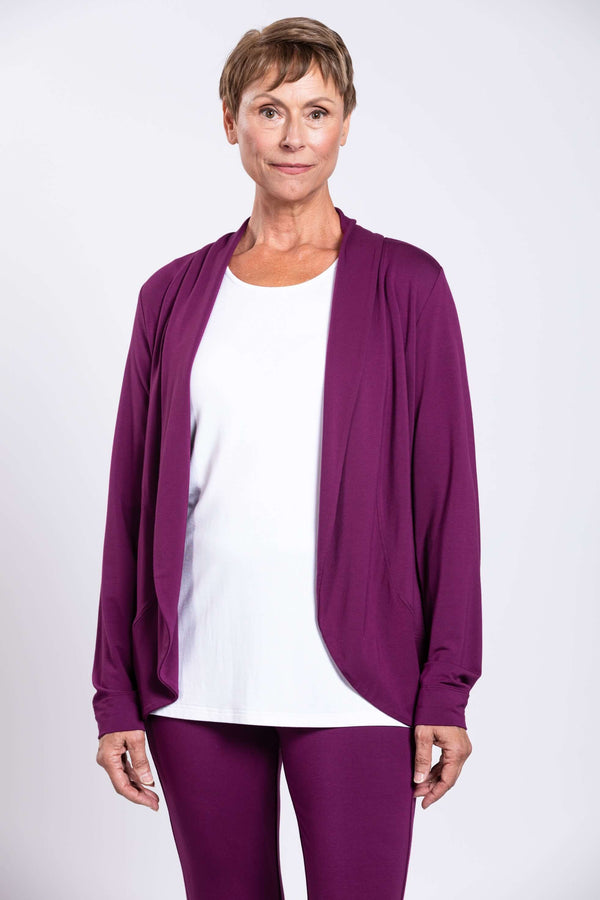 Front view of a woman wearing a plum bamboo French terry jacket over a white top