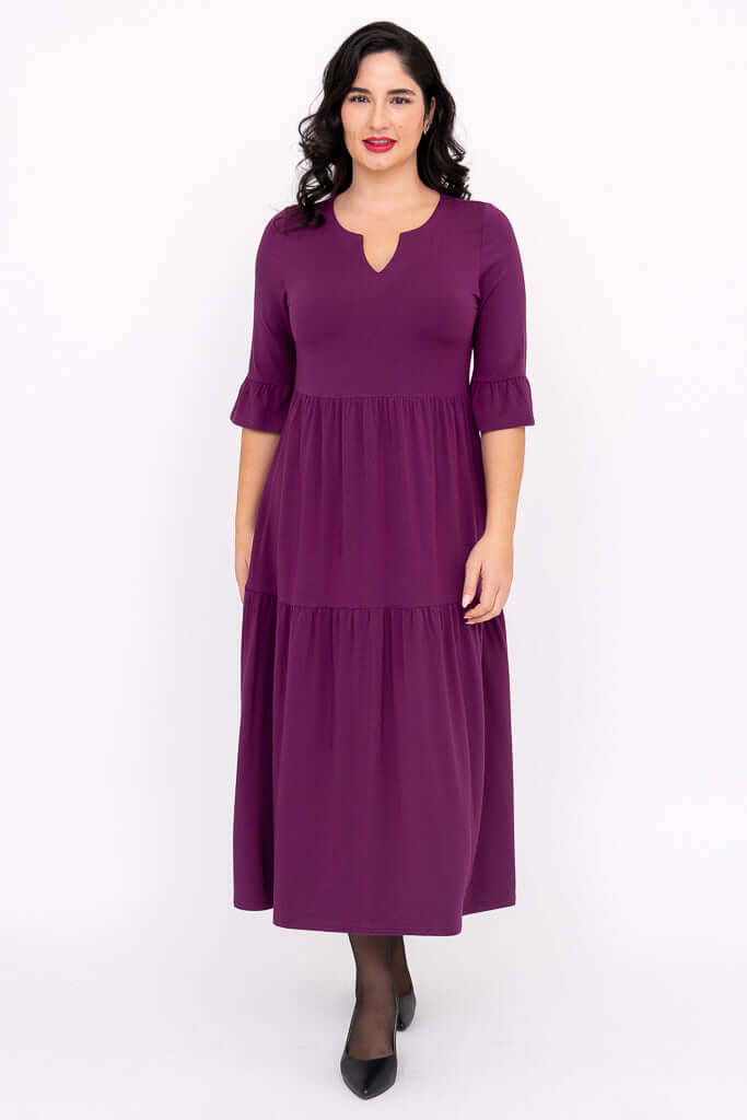 Front view of woman wearing a purple Bernadette long dress with keyhole neckline