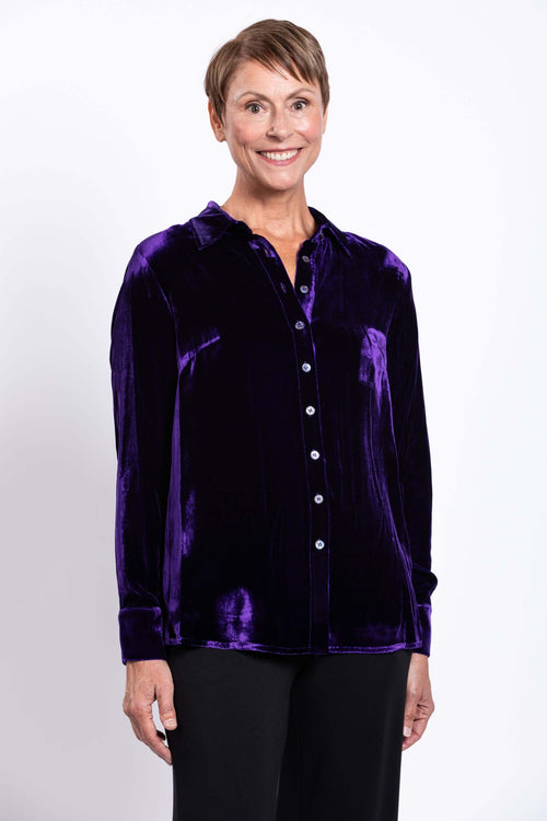 Front view of woman wearing purple silk velvet blouse with button closure