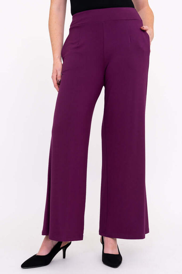 Front view of a model wearing purple wide leg bamboo pants with pockets