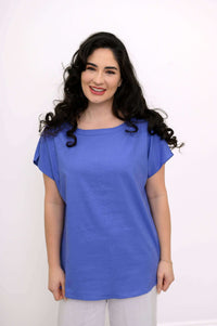 Woman wearing a relaxed blue boatneck tee with short dolman sleeves, front view