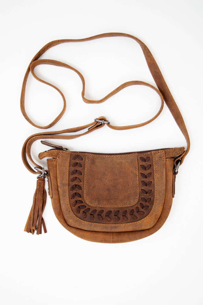 Front view of brown leather crossbody bag with decorative stitching and tassel zipper