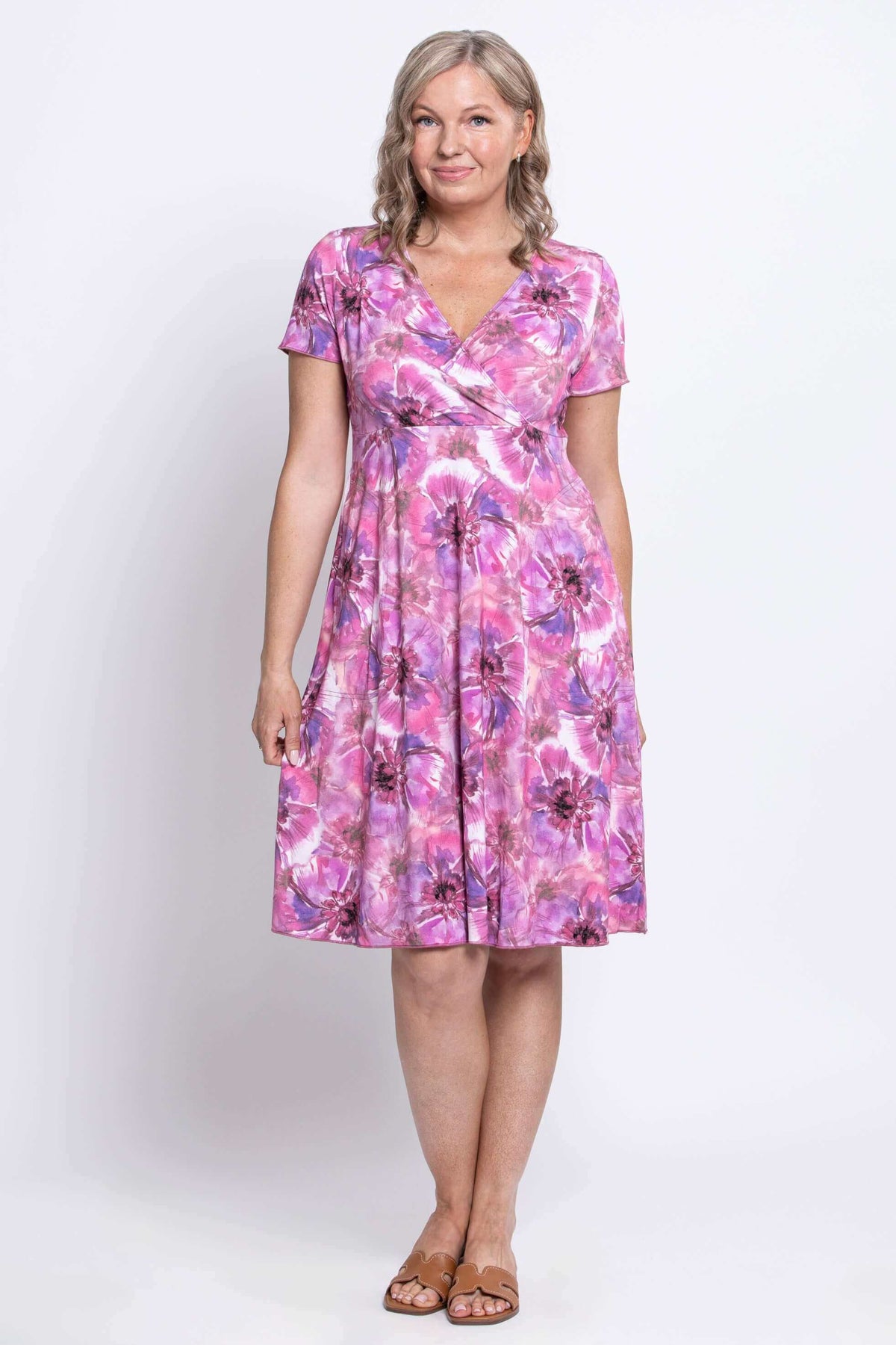 Front view of woman in short-sleeve pink floral bamboo crossover dress
