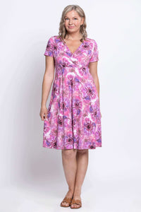 Front view of woman in short-sleeve pink floral bamboo crossover dress