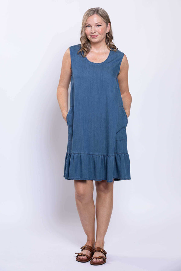 Front view of model wearing sleeveless blue dress with ruffle hem and pockets