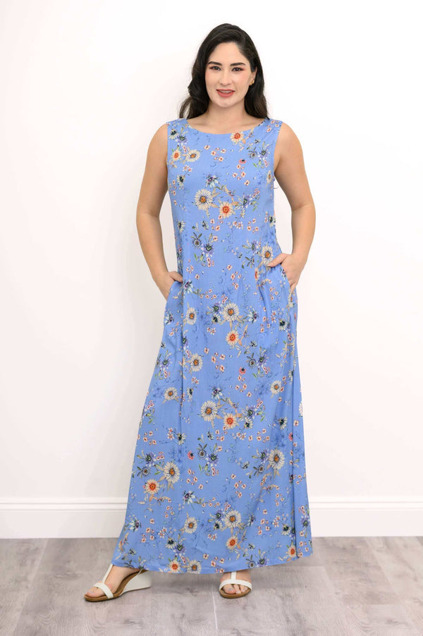 Front view of woman wearing a sleeveless blue floral shift maxi dress with pockets