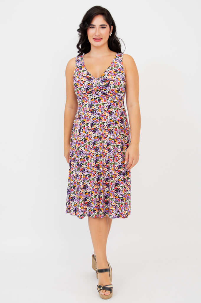 Woman wearing a sleeveless, knee-length floral fit and flare dress