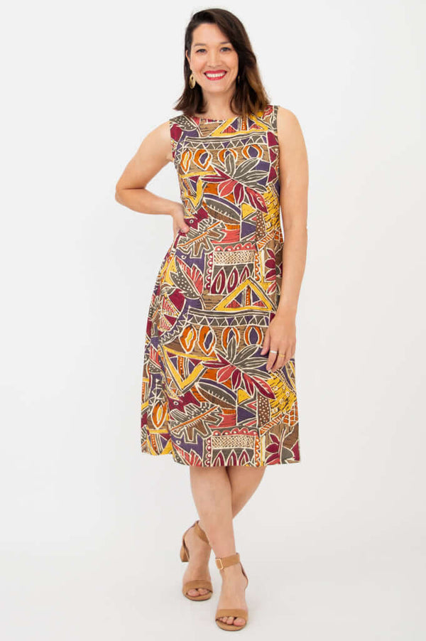 Woman wearing sleeveless print shift dress with relaxed fit, front view
