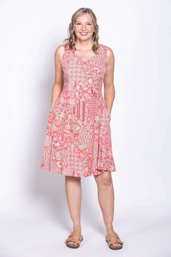 Front view of woman wearing a sleeveless patchwork print summer dress with pockets