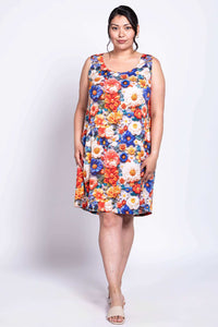 Front view of model wearing a sleeveless shift dress with vibrant floral print
