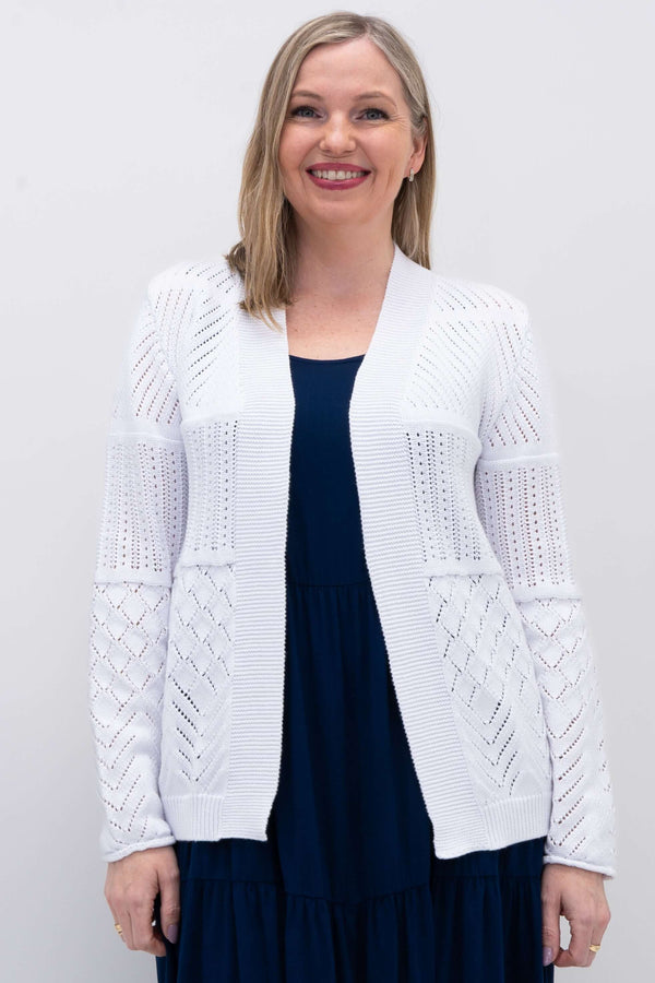 Front view of woman wearing a white pointelle knit open cardigan